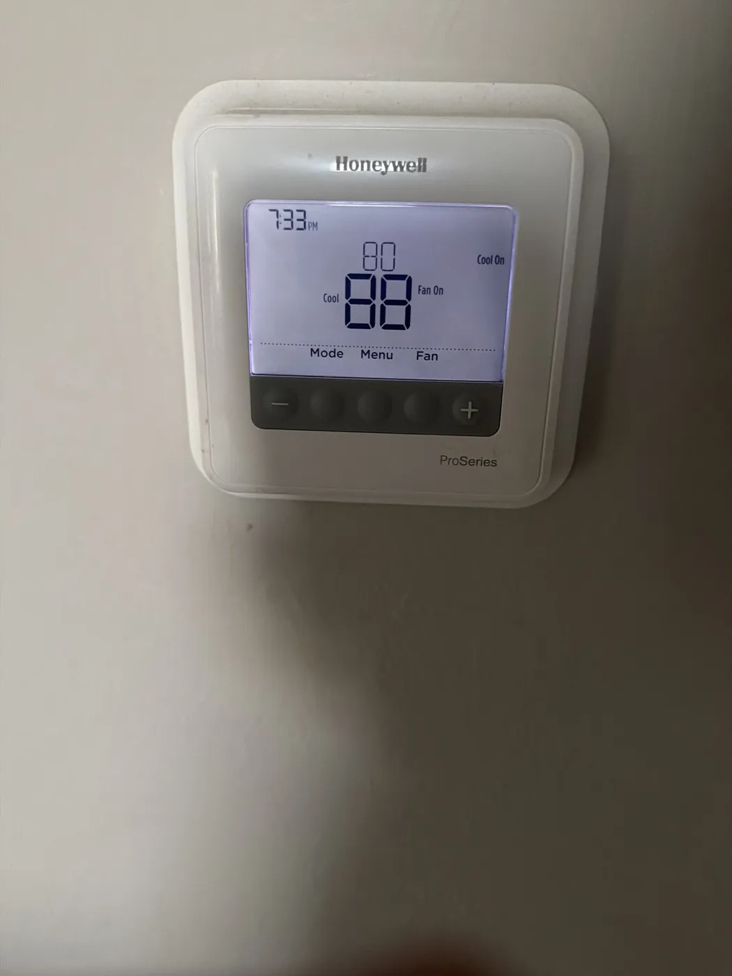 A wall thermostat set to cool to 80 while the room temperature reads 88, with Cool On and Fan On showing